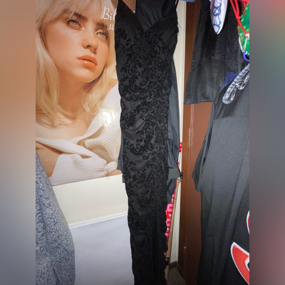 Long black prom or hoco dress with floral pattern and slit in leg